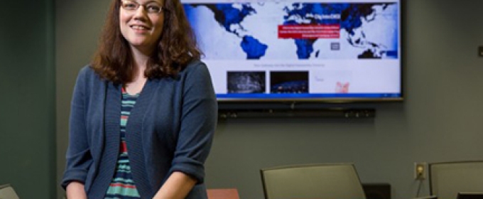 woman with flat screen TV in background, classroom