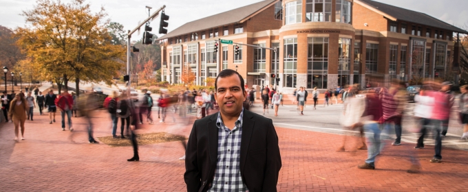 Photo of man with blurred crowds, street, in background