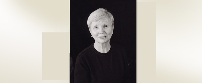 headshot of woman on black back ground with color block