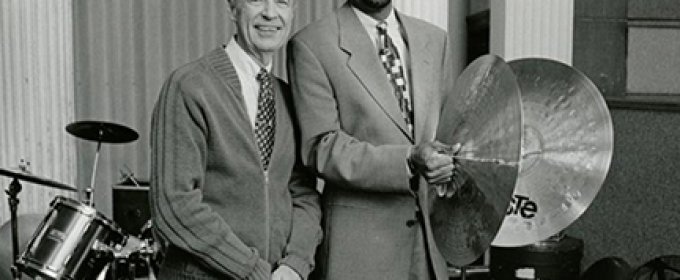 black and white photo of two men, with drums and cymbals