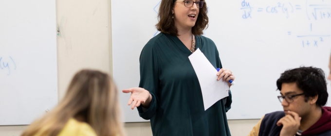 photo of woman speaking to students in classroom