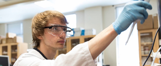 photo of young man in lab with goggles