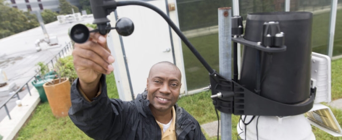 photo of man with wind gauge equipment, outside