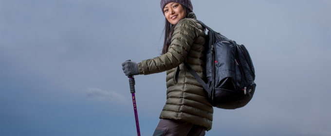 photo of woman on mountain hike, with walking stick