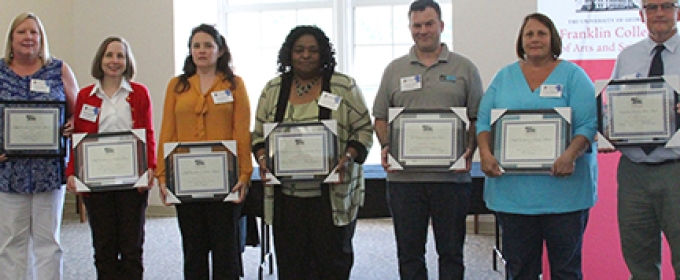 7 people with award plaques