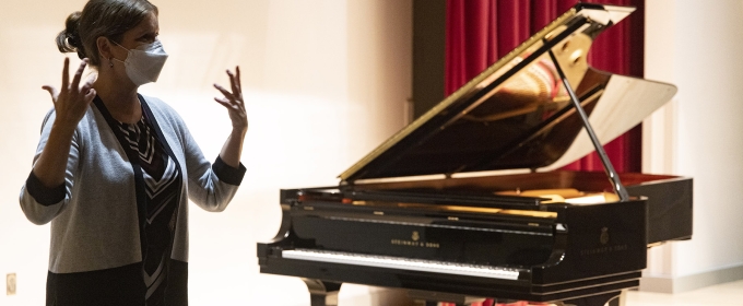 photo of woman with piano in background