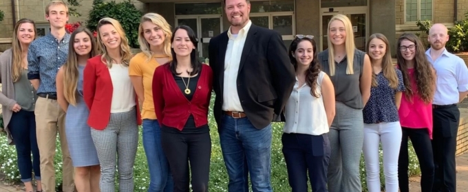 group photo of men and woman outdoors