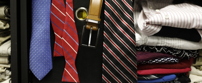 photo of ties, belts and folded shirts