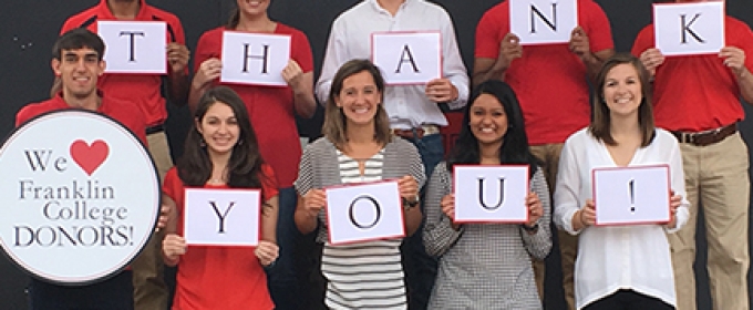 students with thank you signs