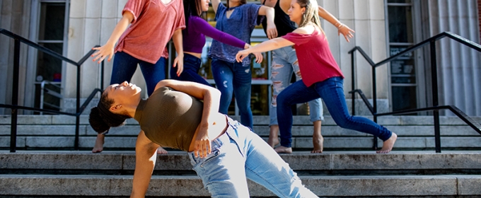 Photo of six women dancers posed on steps