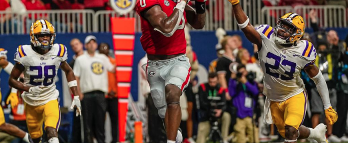 photo of in game football action, three players, fans in background