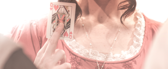 promo photo of woman holding playing card