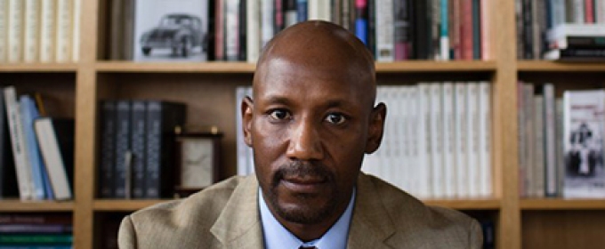 photo of man with bookshelves