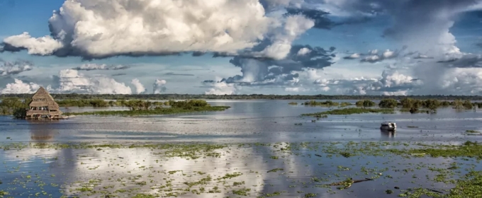 photo of flooded river, with clouds, day