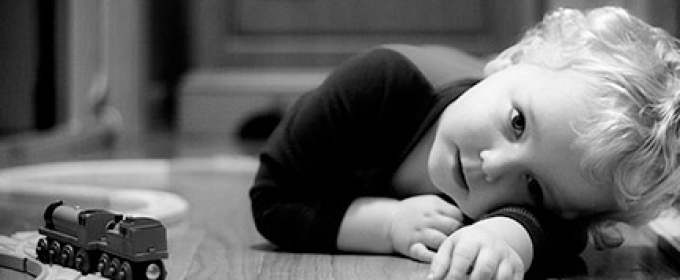 child in b/w with trains 