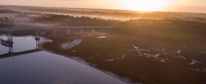 aerial photo of a coastal marsh, with bridge