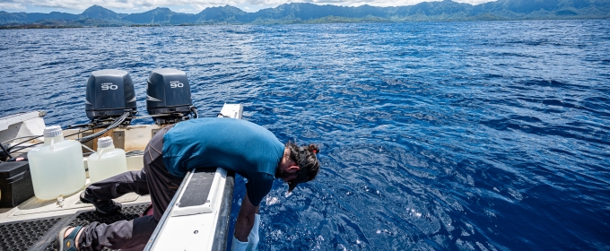 photo of man in boat in the ocean