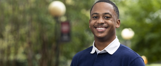 Photo of man in blue shirt outdoors, day