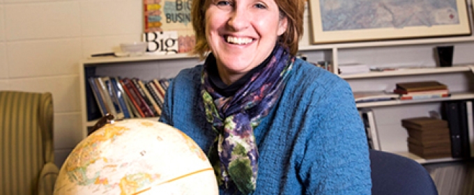 photo of woman with globe