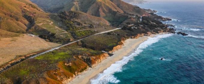 aerial photo of the California coast, with mountains and ocean