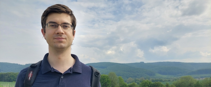 photo of man, field of yellow flowers in background