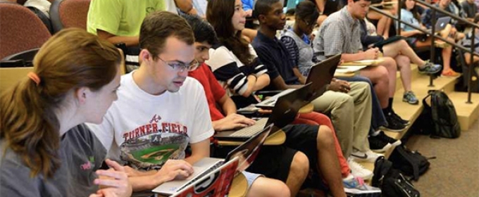 photo of students auditorium classroom with laptops